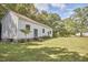 Exterior view of a charming white home with trees at 3679 Oak Lawn Farm Rd, Oxford, NC 27565