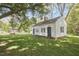 Exterior view of a white home with well-manicured lawn and mature trees at 3679 Oak Lawn Farm Rd, Oxford, NC 27565