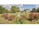 Expansive backyard landscaping with antique doorframe and farmhouse in the background at 3679 Oak Lawn Farm Rd, Oxford, NC 27565