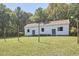 Charming exterior view with string lights on posts surrounding a white home at 3679 Oak Lawn Farm Rd, Oxford, NC 27565