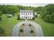 A stunning colonial style home with a sprawling front yard, and a circular driveway at 3679 Oak Lawn Farm Rd, Oxford, NC 27565