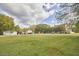 Spacious home with a large, well-maintained lawn and various outbuildings, perfect for outdoor activities at 3679 Oak Lawn Farm Rd, Oxford, NC 27565