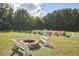 Well manicured exterior grounds featuring a fire pit and lush landscaping at 3679 Oak Lawn Farm Rd, Oxford, NC 27565