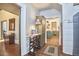 Inviting hallway leading to an open kitchen and featuring original wood floors at 3679 Oak Lawn Farm Rd, Oxford, NC 27565
