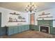 Open kitchen with ample cabinetry, wood floors, and a fireplace at 3679 Oak Lawn Farm Rd, Oxford, NC 27565