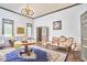Spacious living room featuring hardwood floors, elegant furniture, and ample lighting at 3679 Oak Lawn Farm Rd, Oxford, NC 27565