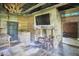 Living room featuring a stone fireplace, television, bar area and plank flooring at 3679 Oak Lawn Farm Rd, Oxford, NC 27565