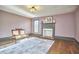 Elegant living room boasting hardwood floors, vintage settee, and a decorative fireplace at 3679 Oak Lawn Farm Rd, Oxford, NC 27565