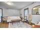 Spacious living room featuring hardwood floors, large windows, and stylish furnishings at 3679 Oak Lawn Farm Rd, Oxford, NC 27565