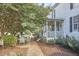 Charming back patio with outdoor seating and mature landscaping at 3679 Oak Lawn Farm Rd, Oxford, NC 27565