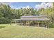 Exterior view of the wooded pavilion area with wooden seating and plenty of space at 3679 Oak Lawn Farm Rd, Oxford, NC 27565