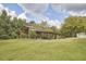 Exterior view of the wooded pavilion area with wooden seating and plenty of space at 3679 Oak Lawn Farm Rd, Oxford, NC 27565