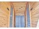 Interior hallway with wooden walls and ceilings leading to the women's and men's restrooms at 3679 Oak Lawn Farm Rd, Oxford, NC 27565