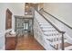 Traditional home staircase featuring wood floors, white risers, and paneled wall at 3679 Oak Lawn Farm Rd, Oxford, NC 27565
