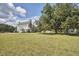 Manicured lawn, mature landscaping and colonial style home, bathed in sunlight at 3679 Oak Lawn Farm Rd, Oxford, NC 27565