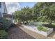 Landscaped yard featuring mature trees, white picket fence, and stone pathways at 3679 Oak Lawn Farm Rd, Oxford, NC 27565