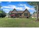 Spacious backyard featuring an outdoor dining area, mature trees, and a view of the home at 3728 Marwick Ct, Wendell, NC 27591