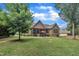 A spacious backyard featuring an outdoor grill, a patio set, a screened in porch and mature trees at 3728 Marwick Ct, Wendell, NC 27591