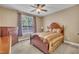 Bedroom features a wooden frame bed, a fan, a window, and a dresser at 3728 Marwick Ct, Wendell, NC 27591