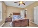 Bedroom features a wooden bed frame, ceiling fan, and neutral paint at 3728 Marwick Ct, Wendell, NC 27591