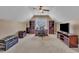 Spacious bonus room with built-in shelving, a ceiling fan, carpet flooring, and natural light at 3728 Marwick Ct, Wendell, NC 27591