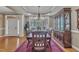 Formal dining room with hardwood floors, large windows, and traditional furnishings, adjacent to the foyer at 3728 Marwick Ct, Wendell, NC 27591