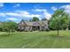 Brick home showcasing a large, well-maintained lawn with mature trees and attractive landscaping at 3728 Marwick Ct, Wendell, NC 27591