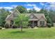 A stately brick home with well-kept lawn and mature trees, presenting a picturesque curb appeal at 3728 Marwick Ct, Wendell, NC 27591