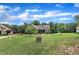 Picturesque front yard featuring a lush green lawn, mature trees, and well-placed landscaping around a charming brick home at 3728 Marwick Ct, Wendell, NC 27591