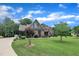 Inviting home with a spacious front yard, manicured lawn, and lush trees lining the curved driveway, offering classic curb appeal at 3728 Marwick Ct, Wendell, NC 27591