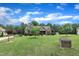 Charming single-Gathering home featuring a well-maintained lawn, mature trees, and beautiful landscaping under a clear blue sky at 3728 Marwick Ct, Wendell, NC 27591