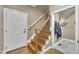 Hallway with hardwood stairs, coat rack, and entry to a mudroom at 3728 Marwick Ct, Wendell, NC 27591