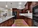 Gourmet kitchen with granite counters, dark cabinetry, subway tile backsplash, and stainless appliances at 3728 Marwick Ct, Wendell, NC 27591