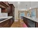Modern kitchen with granite countertops, subway tile, and dark wood cabinets flowing into dining area at 3728 Marwick Ct, Wendell, NC 27591