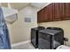 Laundry room with modern washer and dryer, and upper cabinets at 3728 Marwick Ct, Wendell, NC 27591