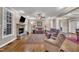 Open living room featuring a stone fireplace, hardwood floors, and comfortable seating at 3728 Marwick Ct, Wendell, NC 27591
