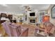 Spacious living room featuring a stone fireplace, hardwood floors, and comfortable seating, open to the kitchen at 3728 Marwick Ct, Wendell, NC 27591