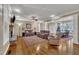 Spacious living room with hardwood floors, fireplace, and comfortable seating flowing into dining area at 3728 Marwick Ct, Wendell, NC 27591