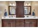 Bathroom features a double sink, mirrors, and dark cabinets at 3728 Marwick Ct, Wendell, NC 27591