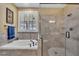 Bathroom featuring a bathtub, shower, and a window to let in natural light at 3728 Marwick Ct, Wendell, NC 27591