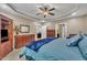 Spacious main bedroom features a fan, wood furniture, and is adjacent to the bathroom at 3728 Marwick Ct, Wendell, NC 27591