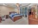 Spacious main bedroom features a tray ceiling, fan, large windows, and wood furniture at 3728 Marwick Ct, Wendell, NC 27591