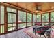 Relaxing screened-in porch with comfortable wicker furniture and a wooded view for serene outdoor living at 3728 Marwick Ct, Wendell, NC 27591