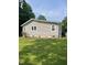 Exterior view of a house with light-colored siding and green grass at 40 Bait Rd, Dunn, NC 28334