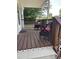 Relaxing front porch furnished with wicker chairs and a wooden floor at 40 Bait Rd, Dunn, NC 28334