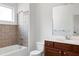 Bathroom featuring a tiled shower/tub combination, vanity with wood cabinets and modern fixtures at 400 W Rosemary St # 114, Chapel Hill, NC 27516