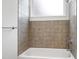 Bathroom featuring a tiled shower/tub combination, and clean white walls at 400 W Rosemary St # 114, Chapel Hill, NC 27516