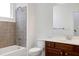 Bathroom featuring a tiled shower/tub combination, vanity with wood cabinets and modern fixtures at 400 W Rosemary St # 114, Chapel Hill, NC 27516