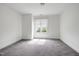 Empty bedroom with gray carpet, neutral walls, white trim, and a window with blinds at 400 W Rosemary St # 114, Chapel Hill, NC 27516