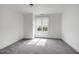 Empty bedroom with gray carpet, neutral walls, white trim, and a window with blinds at 400 W Rosemary St # 114, Chapel Hill, NC 27516